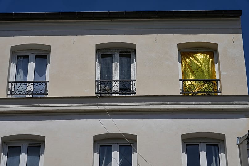 A thermal blanket covers a window to help keep out the heat during a heatwave in Saint-Germain-en-Laye, west of Paris, Thursday, June 25, 2026. 