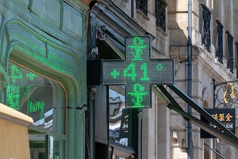 A drugstore sign shows the temperature of 41 degrees Celsius (105,8 degrees Fahrenheit) in Bordeaux, southwestern France, on 23 June 2026