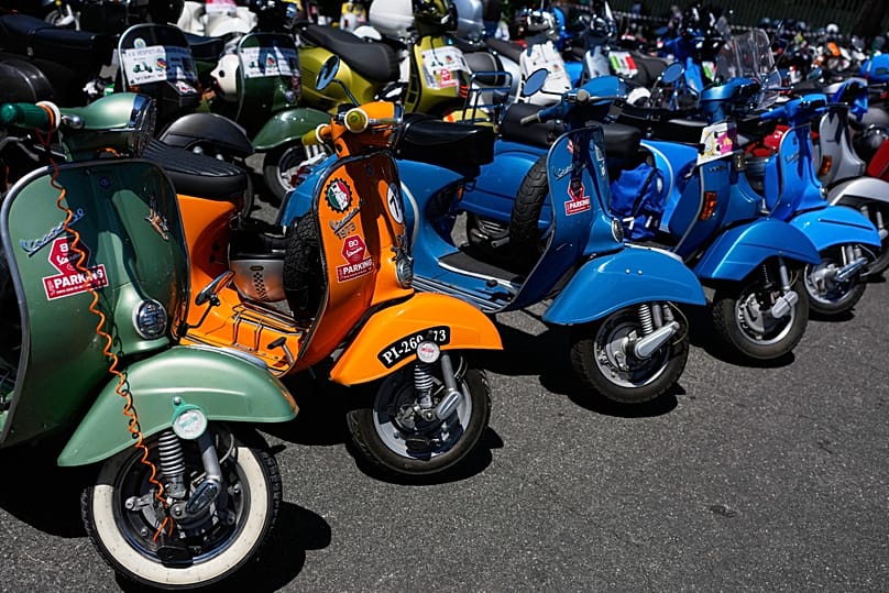 Several Vespa scooters are parked in front of the Vespa Village during celebrations for the 80th anniversary of the Vespa scooter in Rome, Thursday 25 June 2026. (AP Photo)