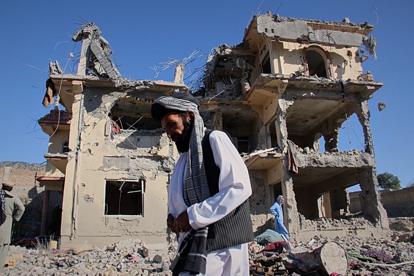Residents walk through the rubble after what Taliban officials said were Pakistani airstrikes in the village of Mandokhail, 29 June, 2026