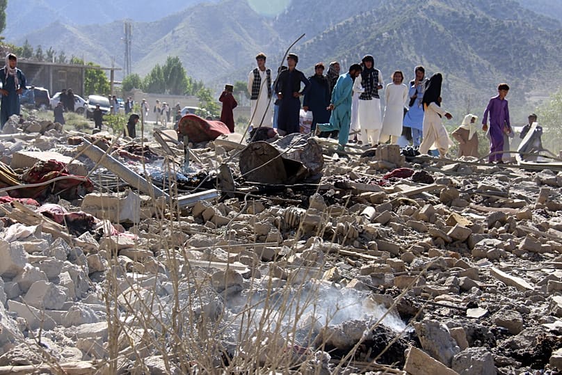 Residents walk through the rubble after what Taliban officials said were Pakistani airstrikes in the village of Mandokhail, 29 June, 2026