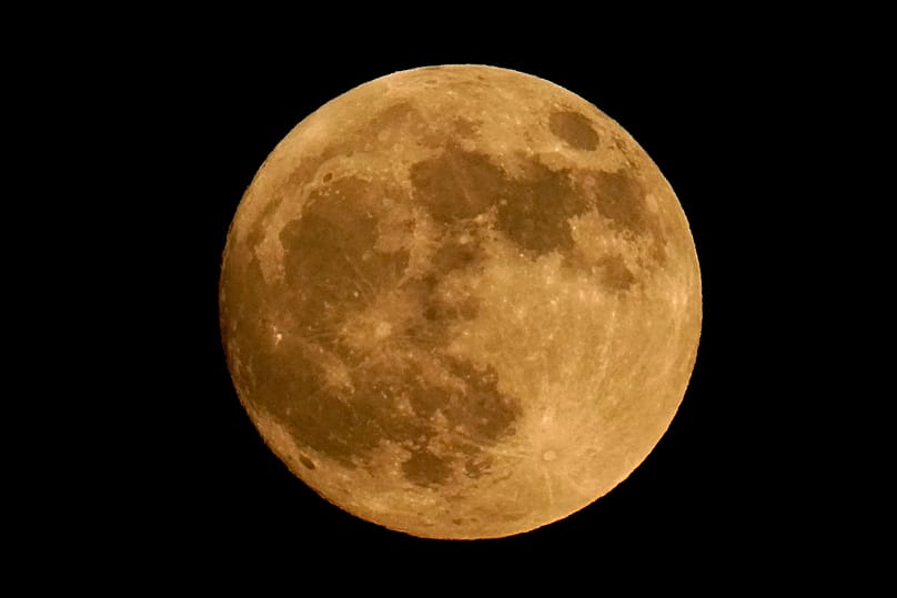 FILE - The moon is seen at 98 percent full as it rises Monday, June 13, 2022, in East Boston, Mass.