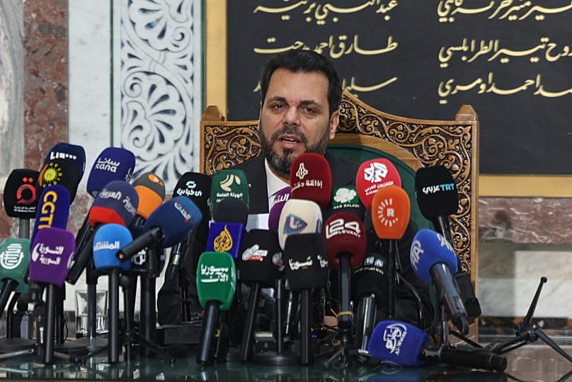 The head of Syria's electoral committee, Mohammed Taha al-Ahmad, speaks during a press conference in Damascus, 1 July, 2026