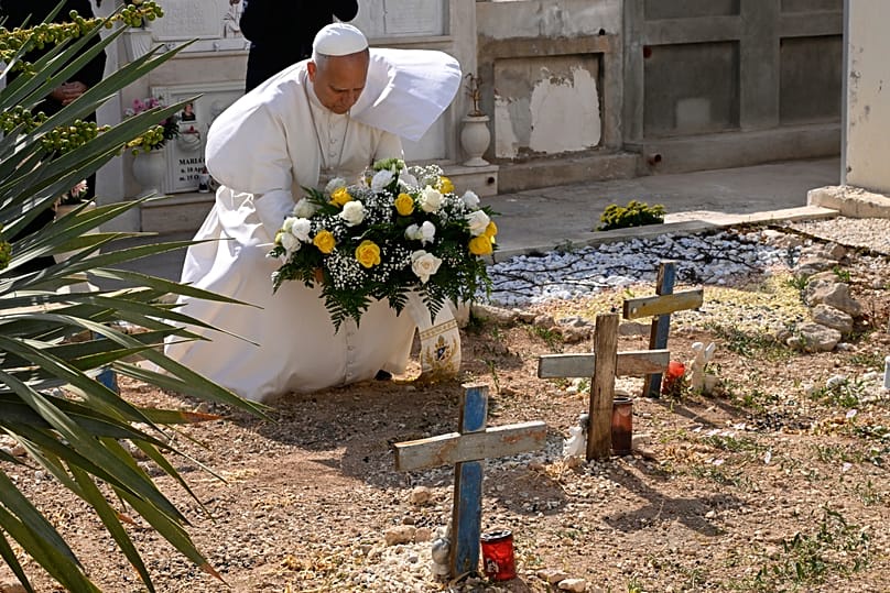 Pope Leo prays over migrants' graves, crosses fashioned from the wood of the boats