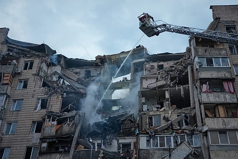 Rescuers work the scene of a building damaged by Russian missile attack in Kyiv, Ukraine, Monday, July 6, 2026. 