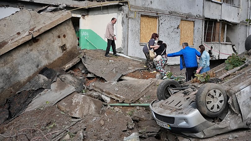 Local residents walk amid debris following a Russian missile attack in Kyiv, 6 July, 2026
