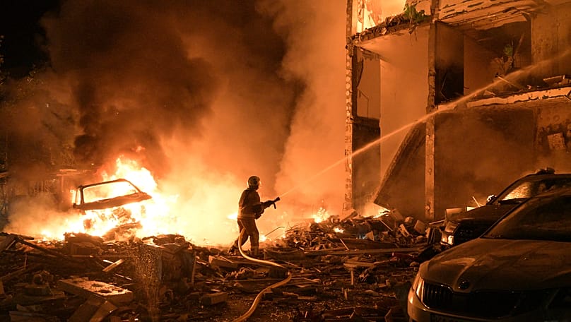 Emergency services personnel work to extinguish a fire following Russian missile attacks in Kyiv, 6 July, 2026