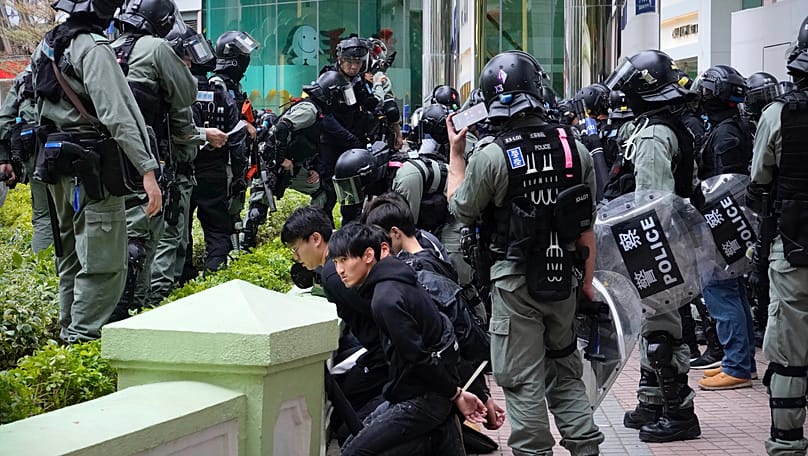 Riot police surround detained protesters during a demonstration in Hong Kong, 5 January, 2020