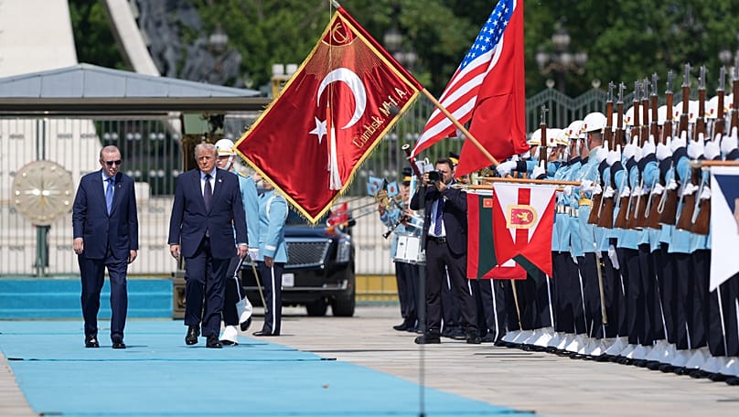 US President Donald Trump walks by an honour guard with Turkish President Recep Tayyip Erdoğan at the Presidential Palace in Ankara, 7 July, 2026