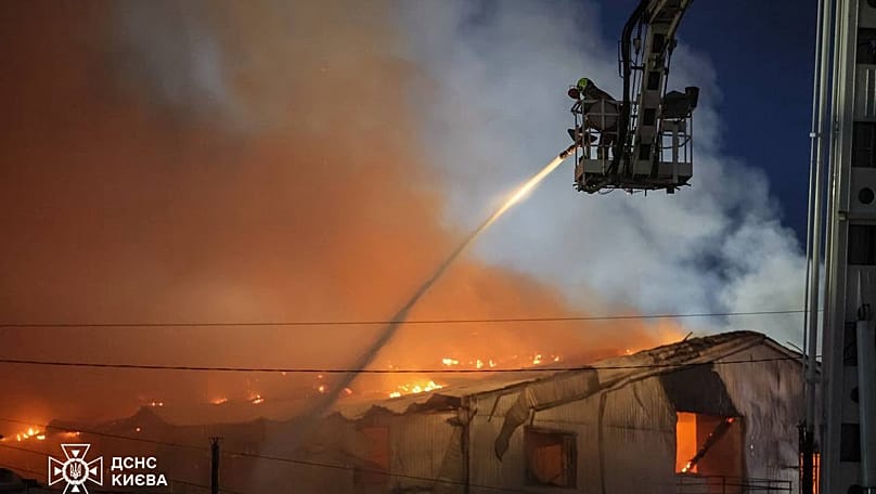 Emergency services personnel work to extinguish a fire following a Russian air attack in Kyiv, Ukraine, Wednesday, July 8, 2026. 