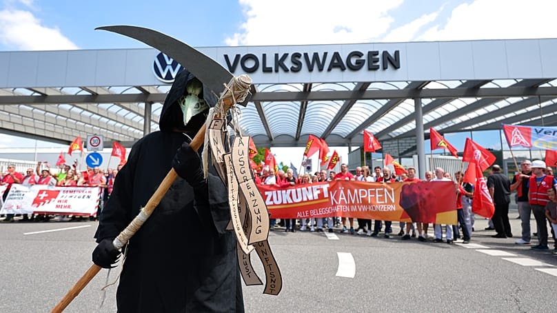 Workers stage a protest outside the Volkswagen plant in Zwickau, 9 July, 2026