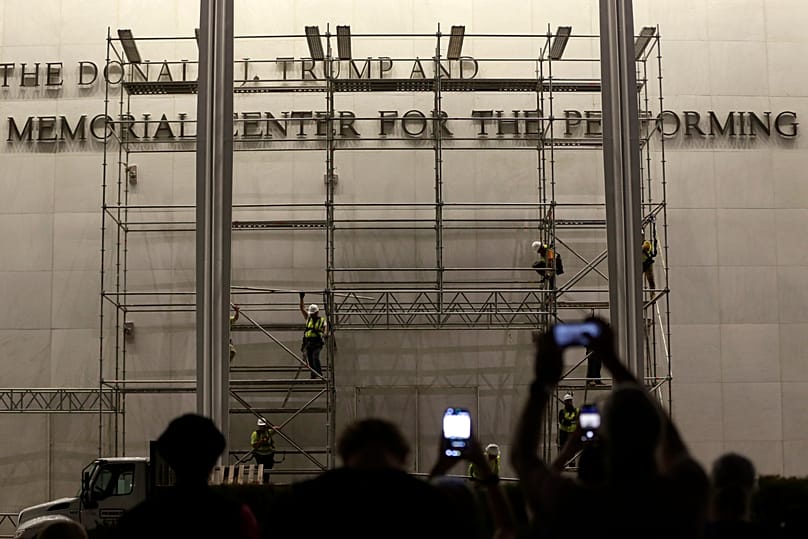 Workers construct scaffolding below the sign for the John F. Kennedy Centre for the Performing Arts, 12 June, 2026
