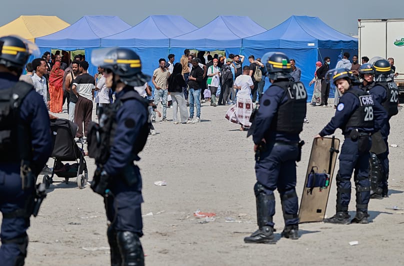 Police conduct a search operation at a makeshift camp of migrants who want to cross the English Channel to Britain near Dunkirk, 27 May, 2026