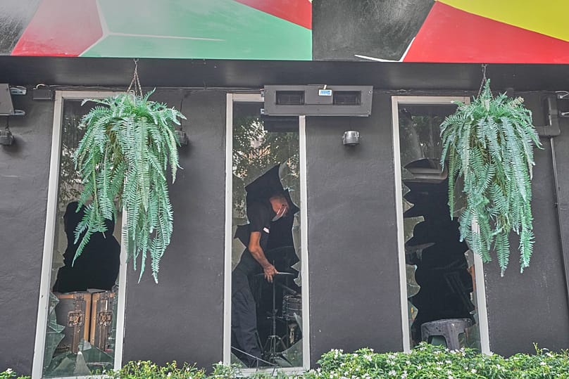A forensic police officer inspects the site of a fire in Bangkok, 13 July, 2026