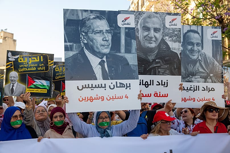 Protesters hold pictures of detained journalists and the sentences handed down against them during a demonstration against Tunisian President Kais Saied in the capital, Tunis, Friday 5 June 2026. (AP Photo/Anis Mili)