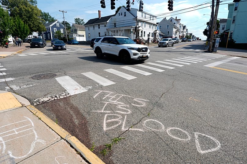 Graffiti on the asphalt indicating that the red stain 