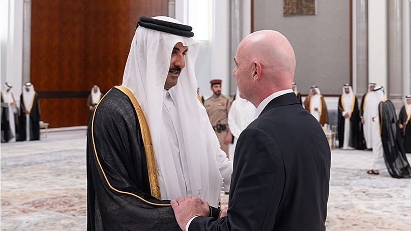 FIFA President Gianni Infantino offers his condolences to Sheikh Tamim bin Hamad Al Thani at the Lusail Palace in Qatar.