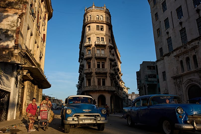 Classic American cars used as taxis drive along a street in Havana, Cuba, Thursday, June 25, 2026. (AP Photo/Ramon Espinosa)