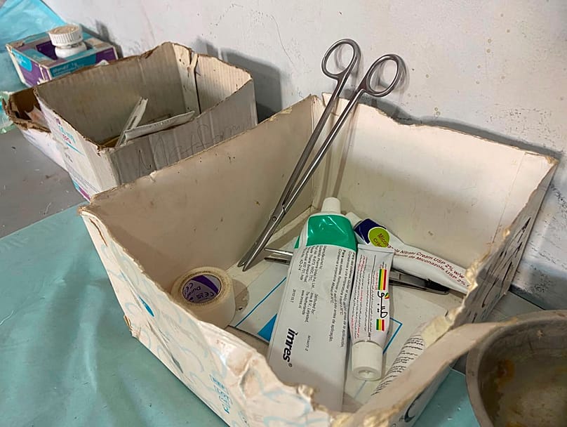 A box that is almost empty of medicines, containing only two ointments because of the shortage of medical supplies