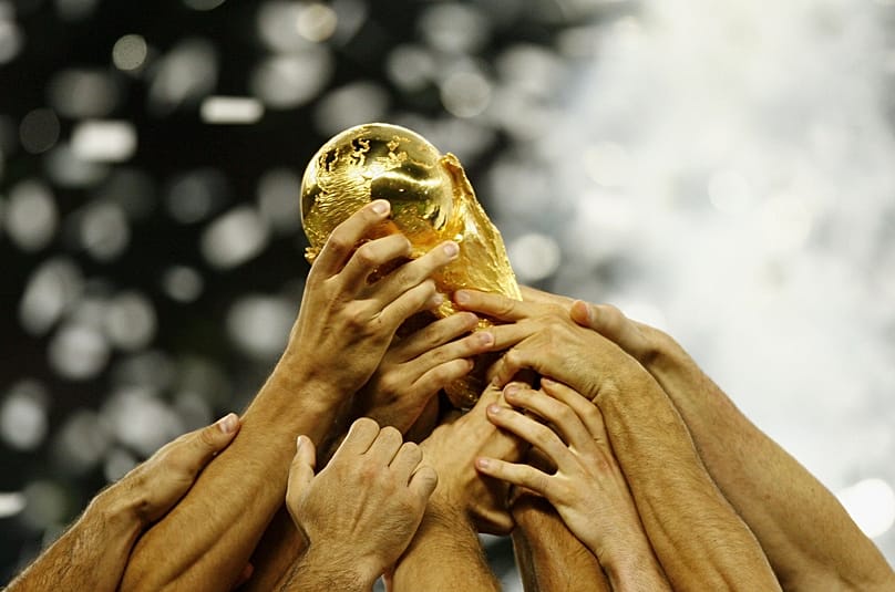 Hands up: Italian players hold aloft the World Cup trophy after their victory over France at the Olympic Stadium in Berlin, Germany, 9 July 2006 