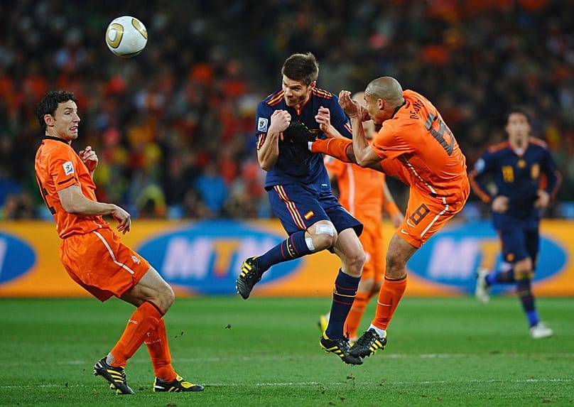 Everybody was kung-fu fighting: Nigel De Jong of the Netherlands tackles Xabi Alonso of Spain at Johannesburg's Soccer City Stadium in South Africa, 11 July 2010.