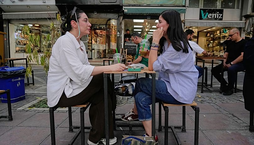 Women sit in the outdoor dining area of a cafe in central Tehran on Wednesday 22 July 2026. (AP Photo/Vahid Salemi)