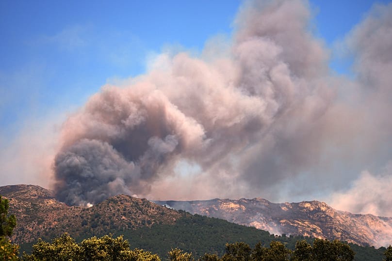 Smoke and flames rise as a wildfire advances near La Adrada, Ávila province, Spain, Friday, July 24, 2026.