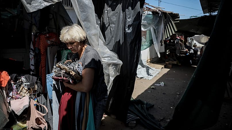 A vendor leaves a market attacked by a Russian drone in the town of Druzhkivka, Donetsk region, Ukraine, 2 August, 2025. 