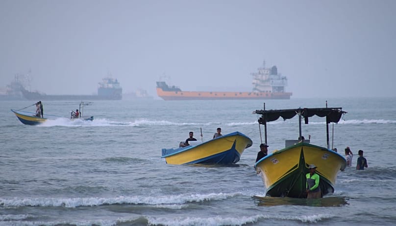 Small boats line the shore as cargo ships and other commercial vessels appear anchored in the Strait of Hormuz off Bandar Abbas, Iran, Monday, July 27, 2026. (Razieh Poudat/IS