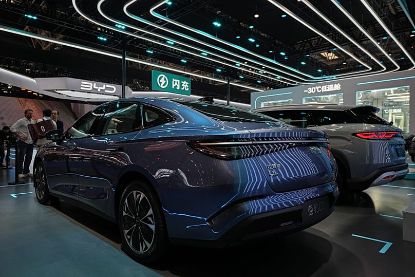 Visitors chat as car models are displayed at the Auto China 2026, in Beijing, Saturday, 25 April 2026.