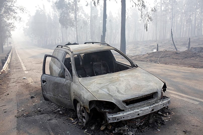 Burnt-out car on the road between Castanheira de Pêra and Figueiró dos Vinhos, near Pedrógão Grande, central Portugal, 18 June 2017