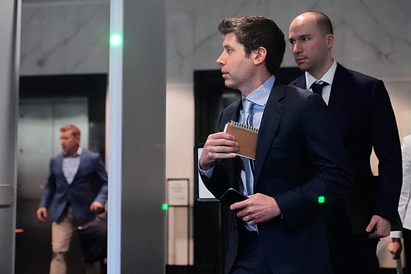 FILE - Sam Altman, center, and OpenAI President Greg Brockman, right, arrive at the U.S. District Court in Oakland, Calif., April 30, 2026