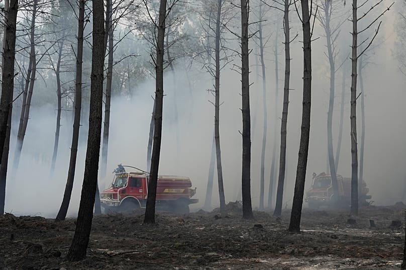 Firefighters work to extinguish a fire, near Blagon, southwestern France, Friday, 31 July 2026
