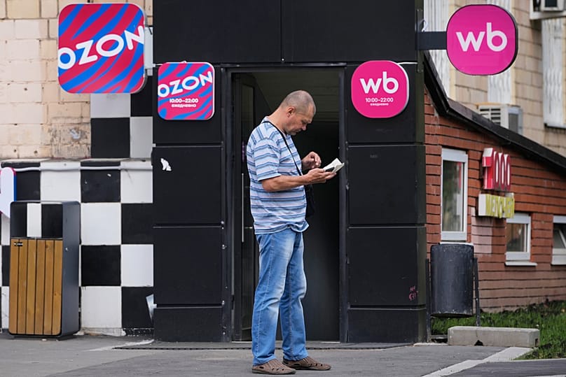 A man stands outside an outlet of Wildberries, Russia's major online retailer, in Moscow on Wednesday, July 22, 2026.