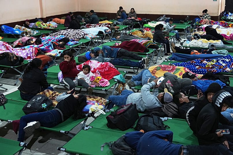 Families evacuated from areas surrounding the Fuego Volcano rest at a temporary shelter in San Juan Alotenango, 4 August, 2026