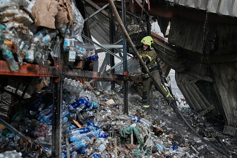 Firefighters put out a fire after Russian missiles hit a food warehouse near Kyiv, 5 August, 2026