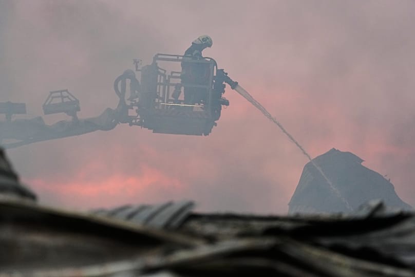 Firefighters put out a fire after Russian missiles hit a food warehouse near Kyiv, 5 August, 2026