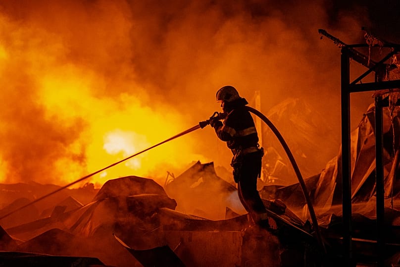 Firefighters put out a fire after Russian missiles hit a warehouse in Kyiv, 5 August, 2026