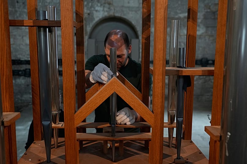 Organ builder Johannes Huefken adjusts a new pipe for a test - 6 July 2026