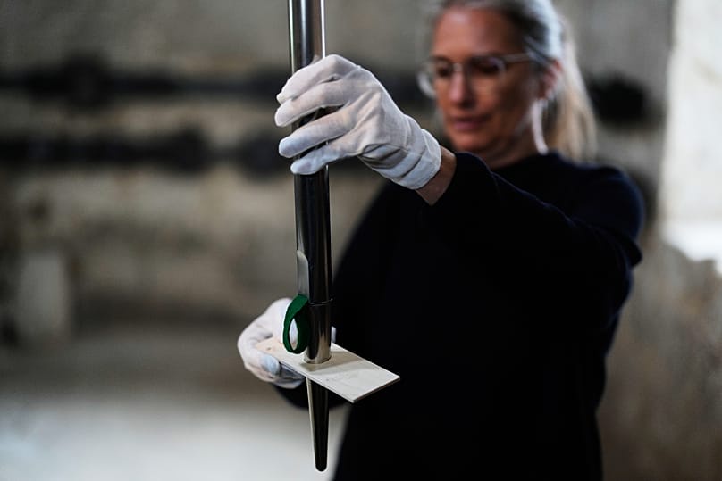 Curator Anneli Borgmann, chairwoman of the John Cage Organ Project Halberstadt's board of trustees, lifts a new pipe for a test - 6 July 2026