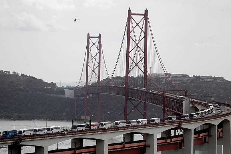Buses carrying demonstrators cross the 25 April Bridge in Lisbon on their way to a CGTP protest against the Government’s austerity measures, on 19 October 2013