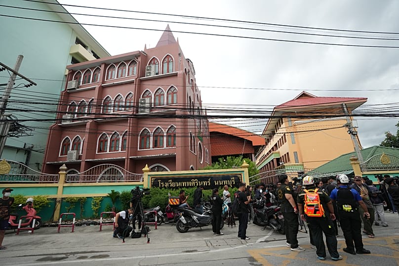 People gather outside after a shooting at the Debsirin Nonthaburi School in Thailand's Nonthaburi province, 7 August, 2026