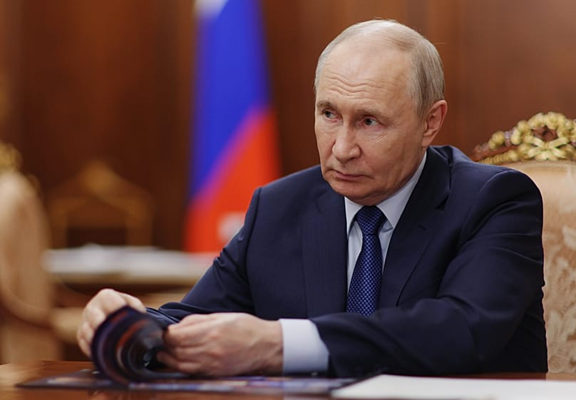 Russian President Vladimir Putin attends a meeting with Deputy Prime Minister - Presidential Envoy to the Far Eastern Federal District Yury Trutnev at the Kremlin in Moscow.
