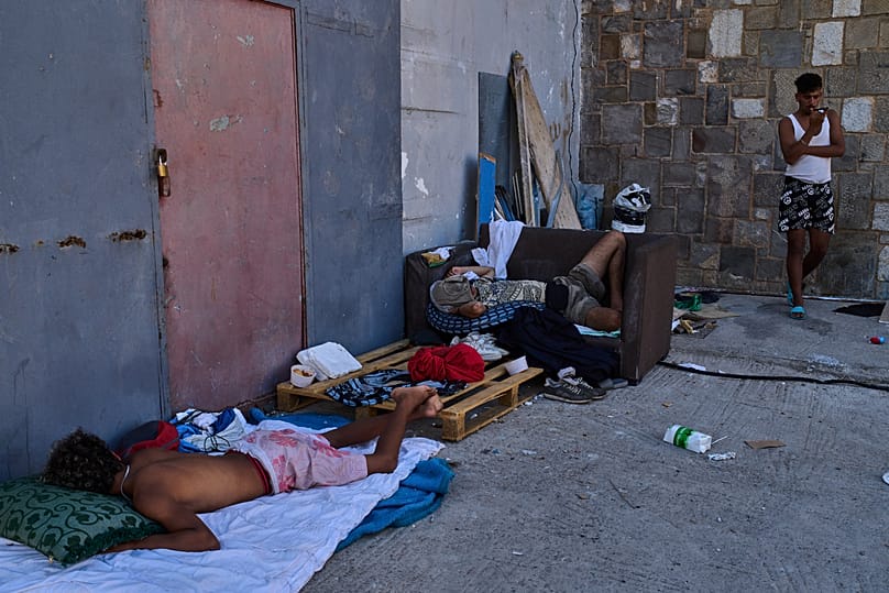 Migrants who crossed from Morocco into Spain sleep in a warehouse near the border between Spain and Morocco, in Ceuta, on 3 August 2026.