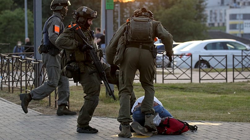 Police officers kick a demonstrator during a mass protest following presidential election in Minsk, Belarus, on 10 August, 2020. 