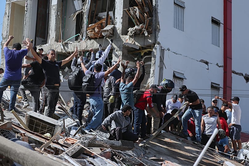Residents and rescue workers search through the rubble of a collapsed building after an earthquake struck Cali, 10 August, 2026