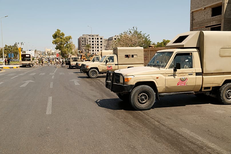 FILE: Libyan army forces and vehicles are stationed in a street in the capital Tripoli, 22 July 222
