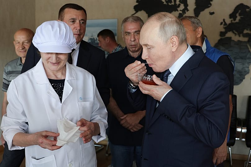 Vladimir Putin samples caviar as he visits the Yasny fish complex at Kitovoye village on Iturup, the largest of the disputed Kuril Islands, on Thursday, Aug. 13, 2026