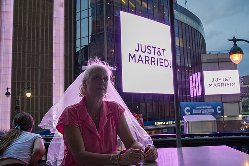 FILE: A Taylor Swift fan celebrates the pop star's marriage to Travis Kelce outside Madison Square Garden, July 3, 2026