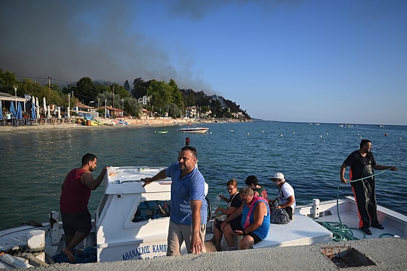 Fishing boats came to the rescue of tourists fleeing the fires in northern Greece. 13 August, 2026.